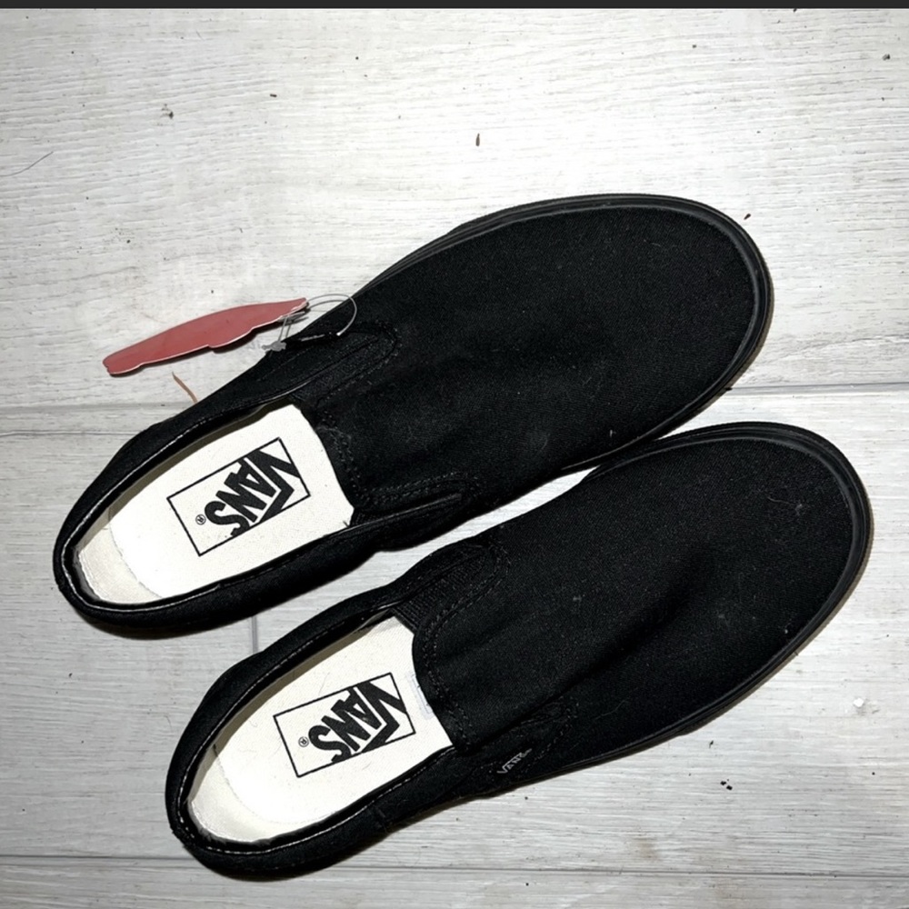 All black slip on vans